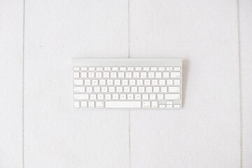 keyboard on white floor with negative space