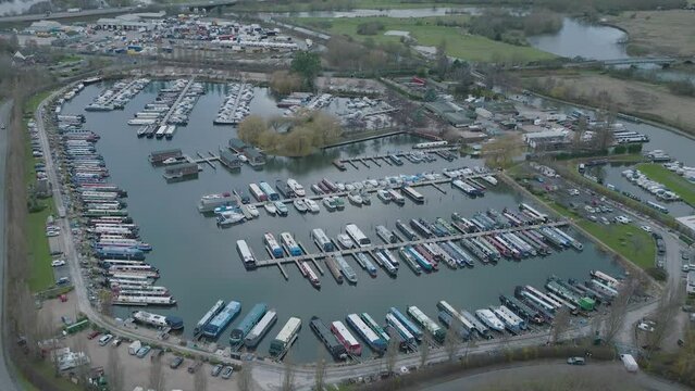 Inland Marina, M1 Motorway, River Trent, Sawley, Nottingham, UK, Boat Mooring, Narrowboats, Leisure Cruisers, Water, Aerial Slow Rise Tilt Down, Dull Day, Travel, Transportation