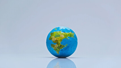 blue globe on grey background with copy space, environmental concept - Powered by Adobe
