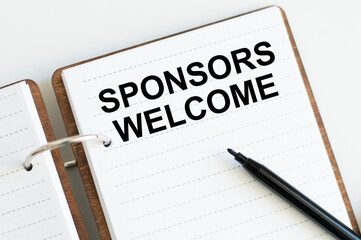 Sponsors Welcome text on an open notebook on a desk, a business concept