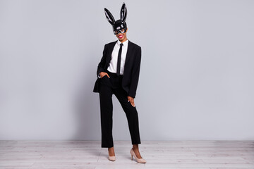 Full size photo of young pretty handsome girl guy wear tux stilettoes mask isolated over grey color background