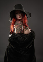 Tattooed plus size woman in fur and hat