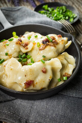 Fried dumplings (pierogi) with meat filling sprinkled with greaves.