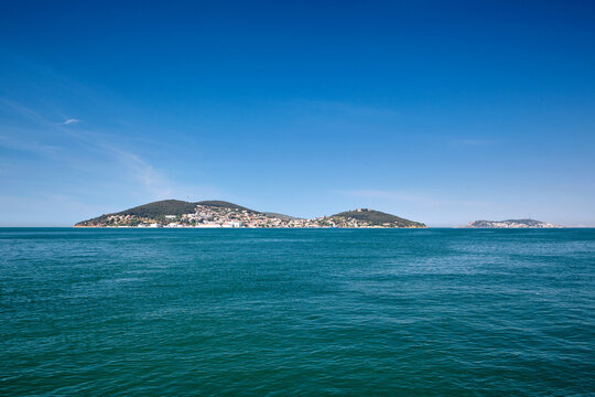 Island with houses in the sea, Blue sea and blue sky. The Sea of Marmara, Heybeliada and Burgazada, Adalar, Prince Islands, Istanbul, Turkey