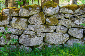 Fototapeta na wymiar Dry Stone Wall with moss in the nature.