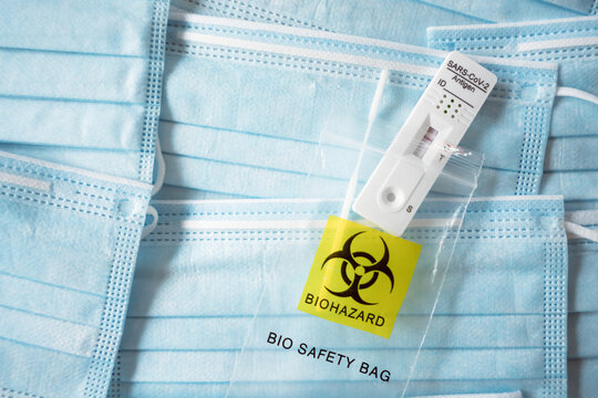 sars cov 2 negative test inside bio safety bag on top of face masks.