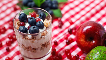 layers of yogurt and crunchy granola with berries on top