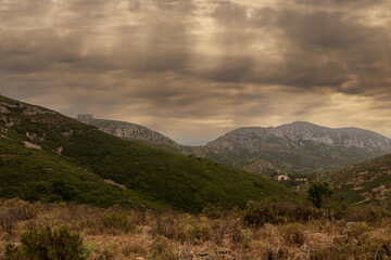 valley in torroella de montgri with the castle on top of the mountain