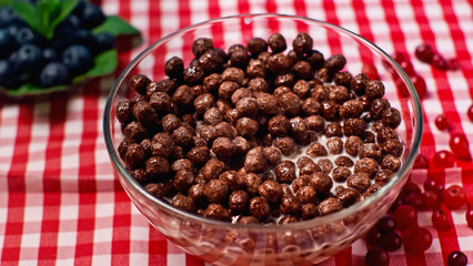 glass bowl with chocolate and crunchy cornflakes with milk