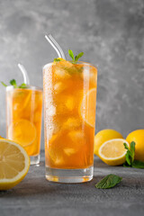 Ice tea or long island cocktail with slice of lemon on a dark background. copy space, selective focus