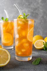 Ice tea or long island cocktail with slice of lemon on a dark background. copy space, selective focus