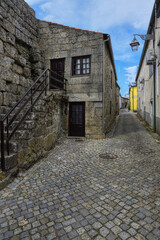 Fototapeta na wymiar Narrow cobble street and old stone houses, Trancoso, Serra da Estrela, Portugal