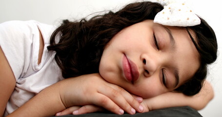 Tired little girl closing eyes, child falling asleep napping