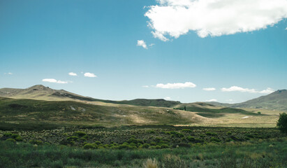 Patagonian meadow in Argentina, rolling landscape with dry grass.