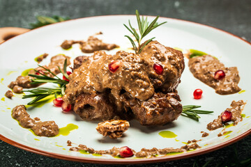 pork medallions with walnut sauce. Georgian cuisine. Ketogenic diet food. Food recipe background. Close up