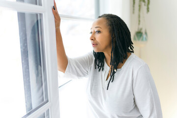 Portrait of an african woman close to a window