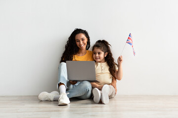 Distance Learning. Arab Woman And Little Daughter Holding Laptop And British Flag