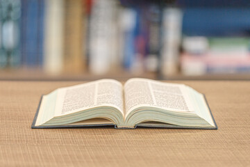 Open book on a wooden table inside the library