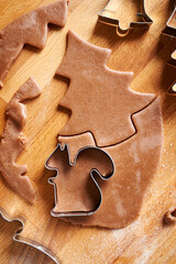 Cutting out shapes from pastry dough for gingerbread Christmas cookies