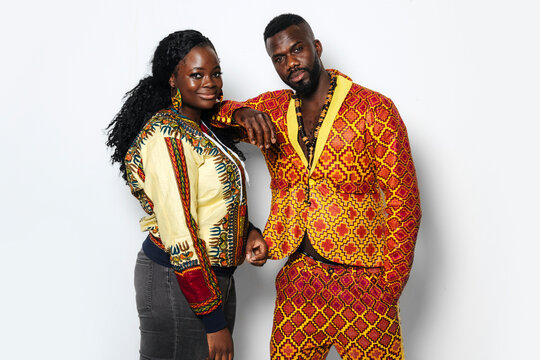 Trendy Couple With African Outfit Hugging In Studio