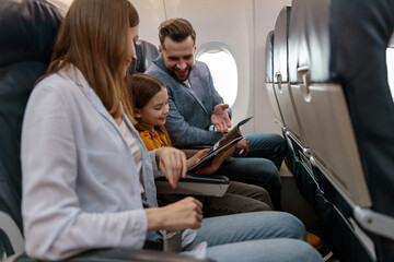 Man and woman traveling with daughter on airplane