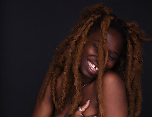 Studio portrait of semi-dress young woman with dreadlocks