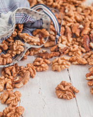 Fresh walnut kernels in eco bag on a wooden background. Organic food concept.