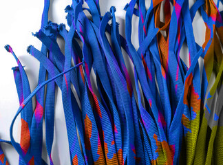 pieces of blue ribbon isolated on a white background. a collection of laces with beautiful colorful...