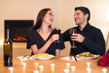 Happy woman and man drinking wine on festive date