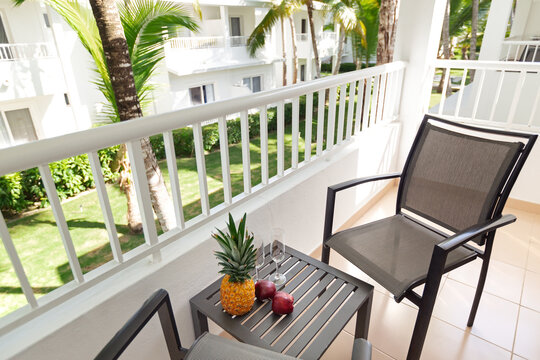 Romantic tropical setting on balcony with palm tree garden