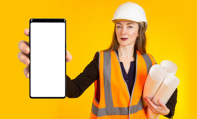Builder phone. Mock up for construction ads on your phone. Woman builder with big phone. Place for...