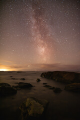 Fototapeta na wymiar Milky Way on rocky shoreline of the Baltic Sea