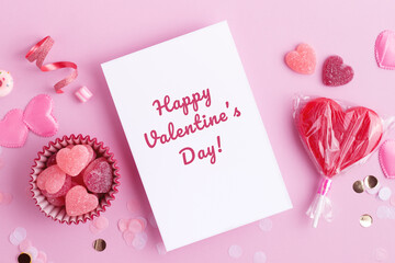 Happy Valentine's day beautiful greeting card with candy hearts and confetti. Red and pink colors, flat lay with holiday love candy decorations.