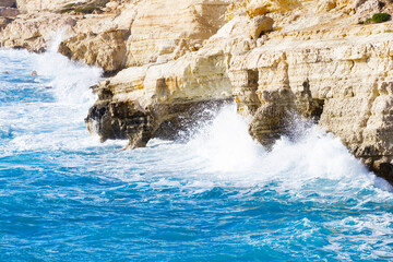 Ocean waves splash against beach with rocks background, Cliffs in the sea, Top aerial view of Cyprus, Nature Background with Sea, Vacation and relax