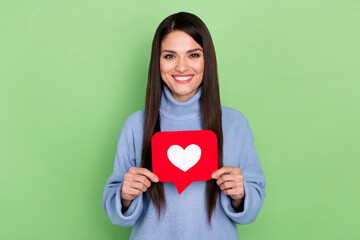 Photo of sweet young brunette lady hold like wear blue sweater isolated on green color background