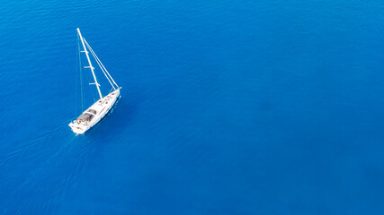 aerial view of couple enjoying sunbathing on the luxury yacht moving in the sea. Travel vacation.
