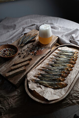 Cold smoked fish on an old wooden board with spices.