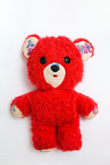 old soft toy - red teddy bear on a white background
