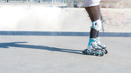 Young girl learning how to roller skate. Active lifestyle concept