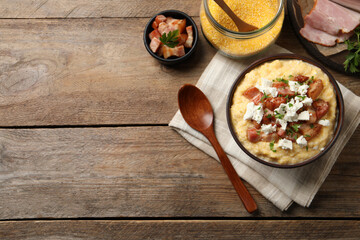 Delicious traditional Ukrainian banosh served on wooden table, flat lay. Space for text