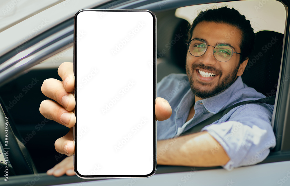 Poster happy indian driver using showing smartphone with empty screen