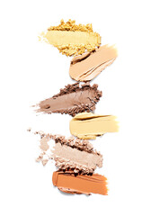 Makeup tone foundation smear, eye shadow, concealer and highlighter isolated on white background. Cosmetic set