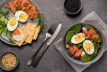 Food photography of salad, boiled eggs, salmon, crackers