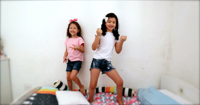 Children dancing to camera, two little girls dance