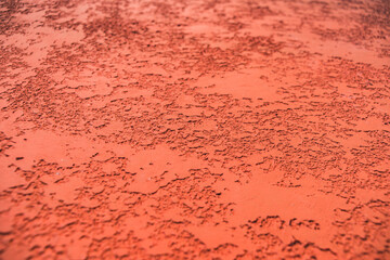 Close-up, texture of a facade made of decorative red plaster.