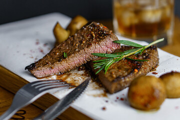Fresh grilled meat. Beef steak medium rare with rosemary brunch and mashrooms on wooden cutting board