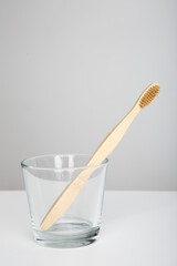 wooden eco friendly toothbrush with cup, bamboo toothbrush on white background