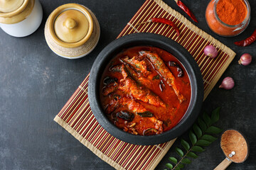 Top view of Sardine fish curry hot spicy Kerala masala fish curry for rice India Indian food red chili curry leaf Asian cuisine. Bengali Goan red fish curry coconut milk, mango clay pot Sri Lanka - obrazy, fototapety, plakaty