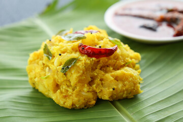 Cooked tapioca or Cassava root Mandioca Aipim Kappa Indian food serving on banana leaf. South Indian food served with meat fish curry Asian cuisine Kerala India Sri Lanka Tamil Nadu