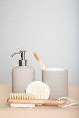 Fototapeta na wymiar wooden eco-friendly toothbrush with cup, bathroom soap dispenser, washcloth and shower brush